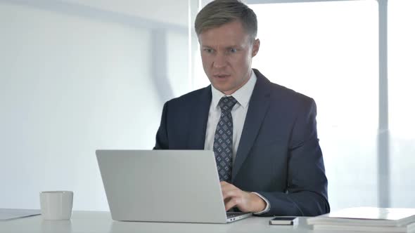 Shocked Businessman Working on Laptop Astonished