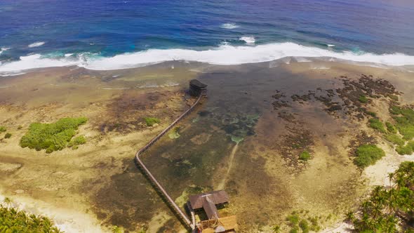 Beautiful Landscape Sunset on the Seashore. Wooden Bridge on Cloud 9 Beach, Siargao Island