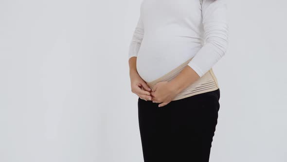 Pregnant Woman Wears a Bandage for Pregnant Women