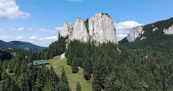 The Lonely Rock Jagged Cliffs With Lush Evergreen Forest