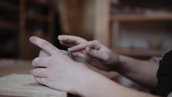 Close-up of female potter working with clay