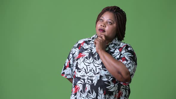 Overweight Beautiful African Woman Against Green Background