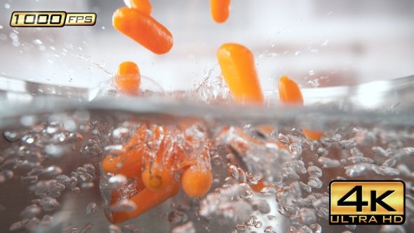 Baby Carrots Falling into Pot with Boiling Water