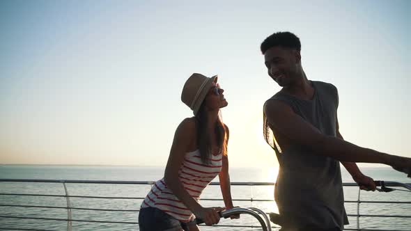 Portrait of a Mixed Race Couple on Tandem Bicycle Outdoors Near the Sea Slow Motion