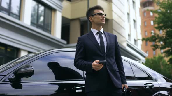 Anxious Young Businessman Waiting for Late Partners, Poor Time Management