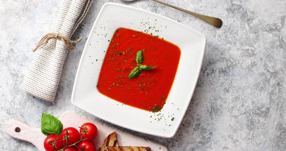 Red Tomato Soup with Crisp Bread and Spoon