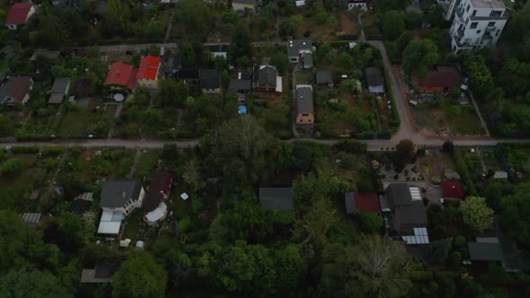 Tilt Down View of Residential Houses with Gardens Next By Multistorey Buildings in Housing Estate