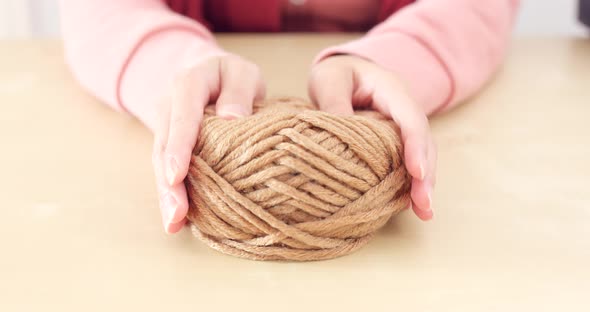 Woman hand holding knit wool ball