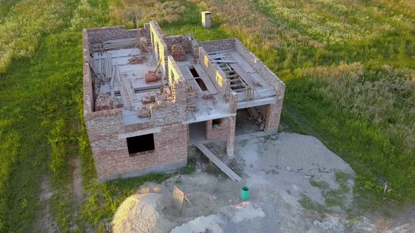 Aerial view od new brick unfinished house under construction.