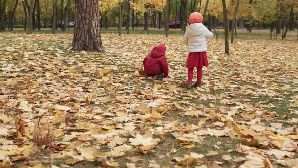 Two Happy Funny Children Kids Boy Girl Walking in Park Forest Enjoying Autumn Fall Nature Weather