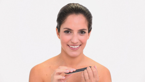 Happy Brunette Woman Filing Her Nails