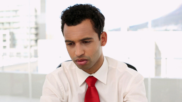 Frowning Handsome Businessman Suffering A Headache