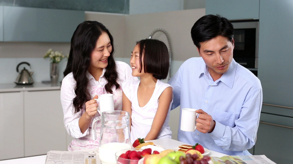 Happy Family Standing In Kitchen