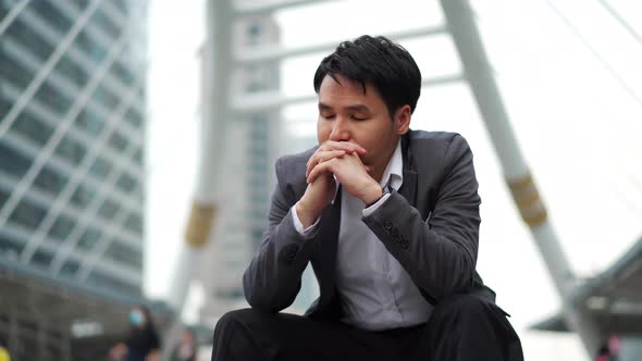 stressed business man sitting on the floor in the city