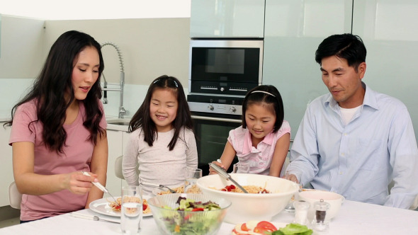 Happy Family Having Spaghetti Dinner Together