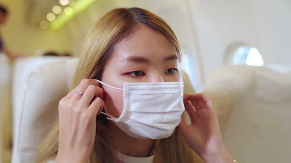 Traveler Wearing Face Mask While Traveling on Commercial Airplane