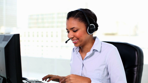 Young Female Agent Working Sitting At Her Desk