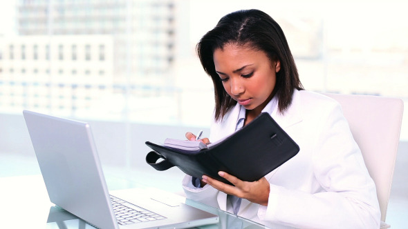 Concentrated Young Businesswoman Writing