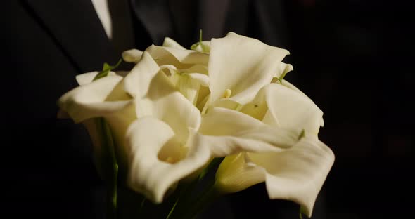 Wedding bouquet in the hand of the groom 