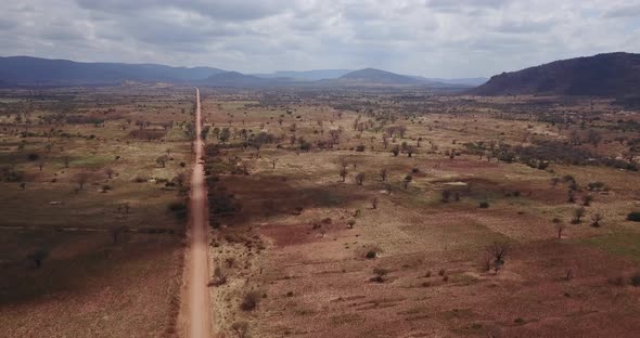 Aerial view of rural Tanzanian savannah during drought season. 4K