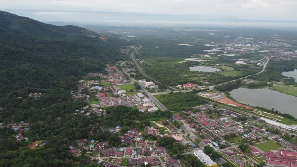 Aerial view panning residential area and abandoned tin mines