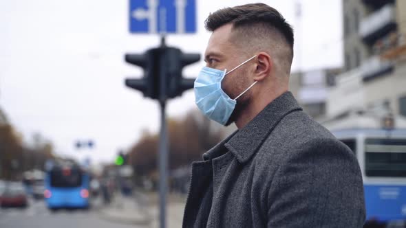 Profile view of male face in mask outdoors