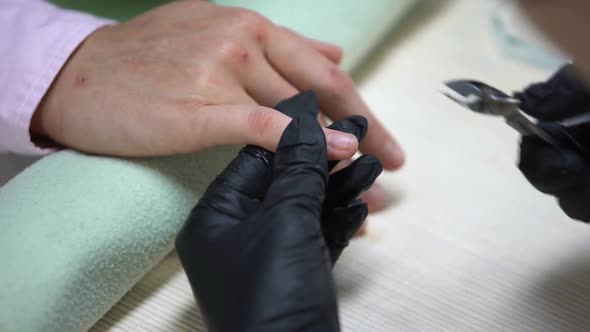 Nail Technician Removing Nails Cuticle With Nipper, Hygiene in Beauty Salon