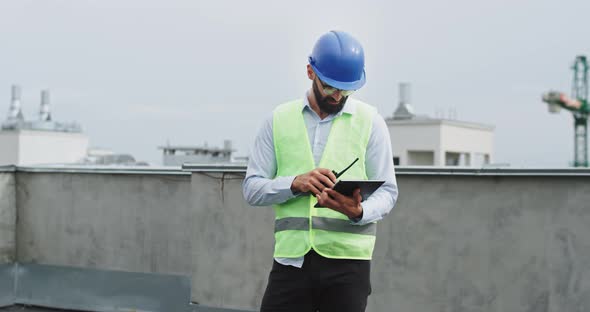 Concentrated Engineer with a Beard Analyzing