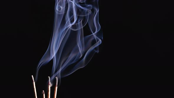 Burning Incense Sticks and Smoke Isolated on Black Background