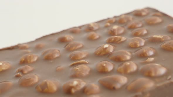 Milk chocolate with whole hazelnuts 4K 2160p 30fps UltraHD  panning footage - Close-up surface of  t