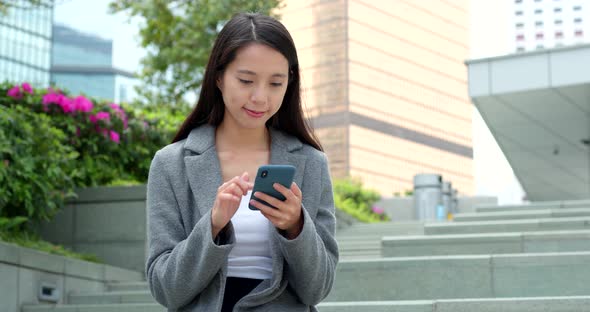 Business woman use of smart phone in city 