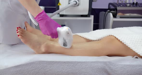 Laser Hair Removal Of Legs With The Help Of A Special Device. Beauty Salon. Beautician