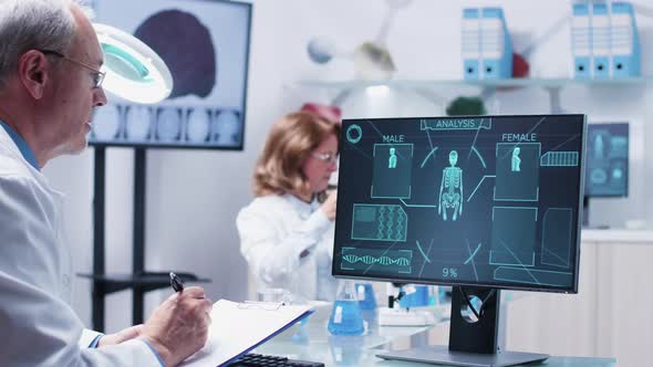 Dolly Shot of Doctor Looking at Advanced Scaning Results alt