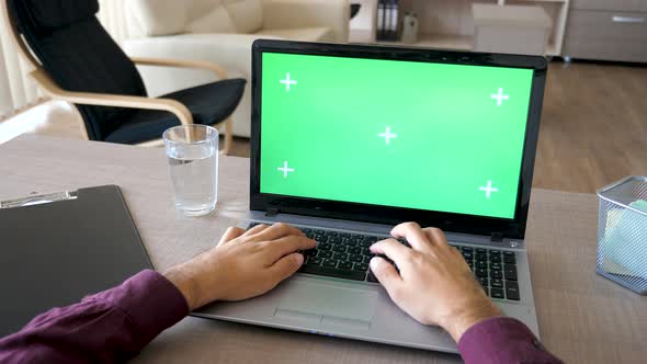 Businessman Hands Typing on Laptop Keyboard with a Green Screen Chroma Mock Up