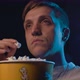 Man watching a boring movie at the cinema and eating popcorn, he is falling asleep - VideoHive Item for Sale