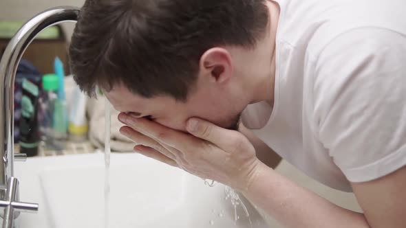 Tired Man Washing His Face.