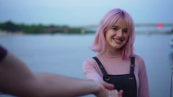 Portrait of Smiling Caucasian Happy Woman Looking at Camera Holding Male Hand Standing on Urban