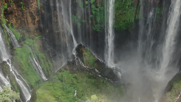 Tumpak Sewu waterfall in tropical forest, aerial footage by drone  