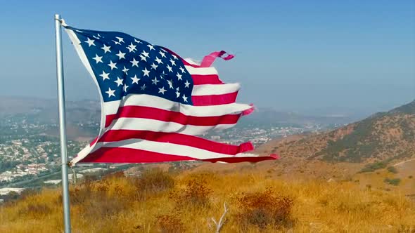 360-Degree Closeup View of the Waving USA Flag Erected on the Grassy Mountain