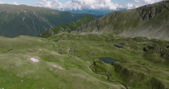 aerial view of mountain range and mountain lakes with smal rivers