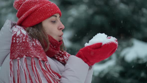 SLOW MOTION Young Woman Blowing Snow