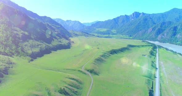 Aerial Rural Mountain Road and Meadow at Sunny Summer Morning