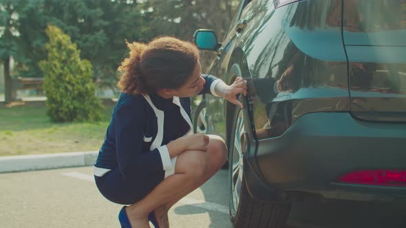 Helpless Woman Looking at Damaged Scratched Car