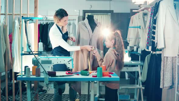 Seamstress and a Girl are Talking Measurements of Clothes