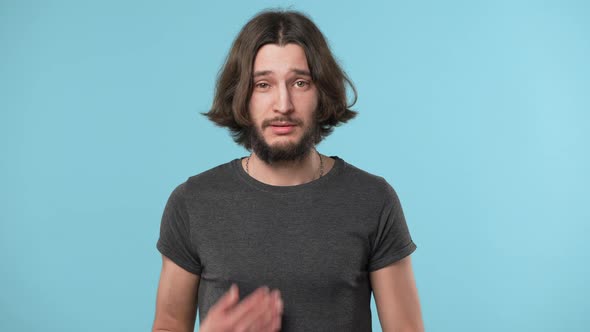 Portrait of Attractive Bearded Man Showing Stop Gesture Meaning He Will Pass or Time to Go Over Blue