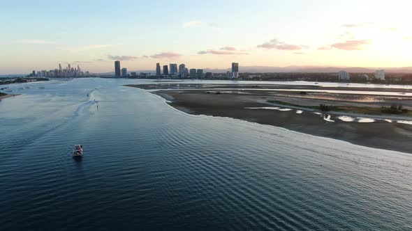 Looking down waterway to Surfers Paradise Low tide at sunset, with exposed sandbar