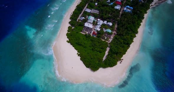 Wide birds eye abstract shot of a paradise sunny white sand beach and aqua blue water background