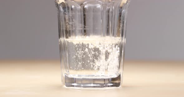 Effervescent Tablet Falls on A Bottom of A Glass 