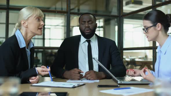 Meditating Businessman in Office Feeling Tired of Shouting Female Conflicts