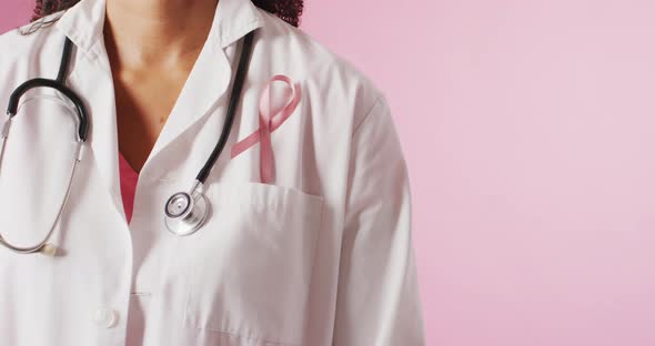Video of biracial female doctor with pink breast cancer ribbon